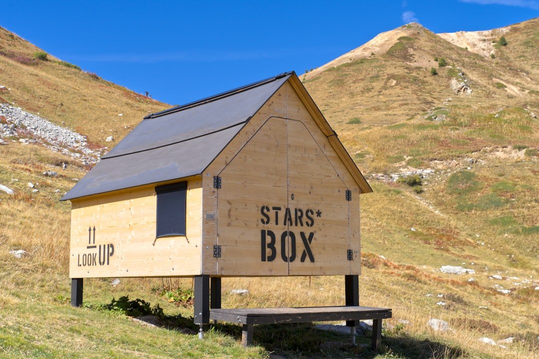 Small wooden cabin with 'stars box' sign on hillside.